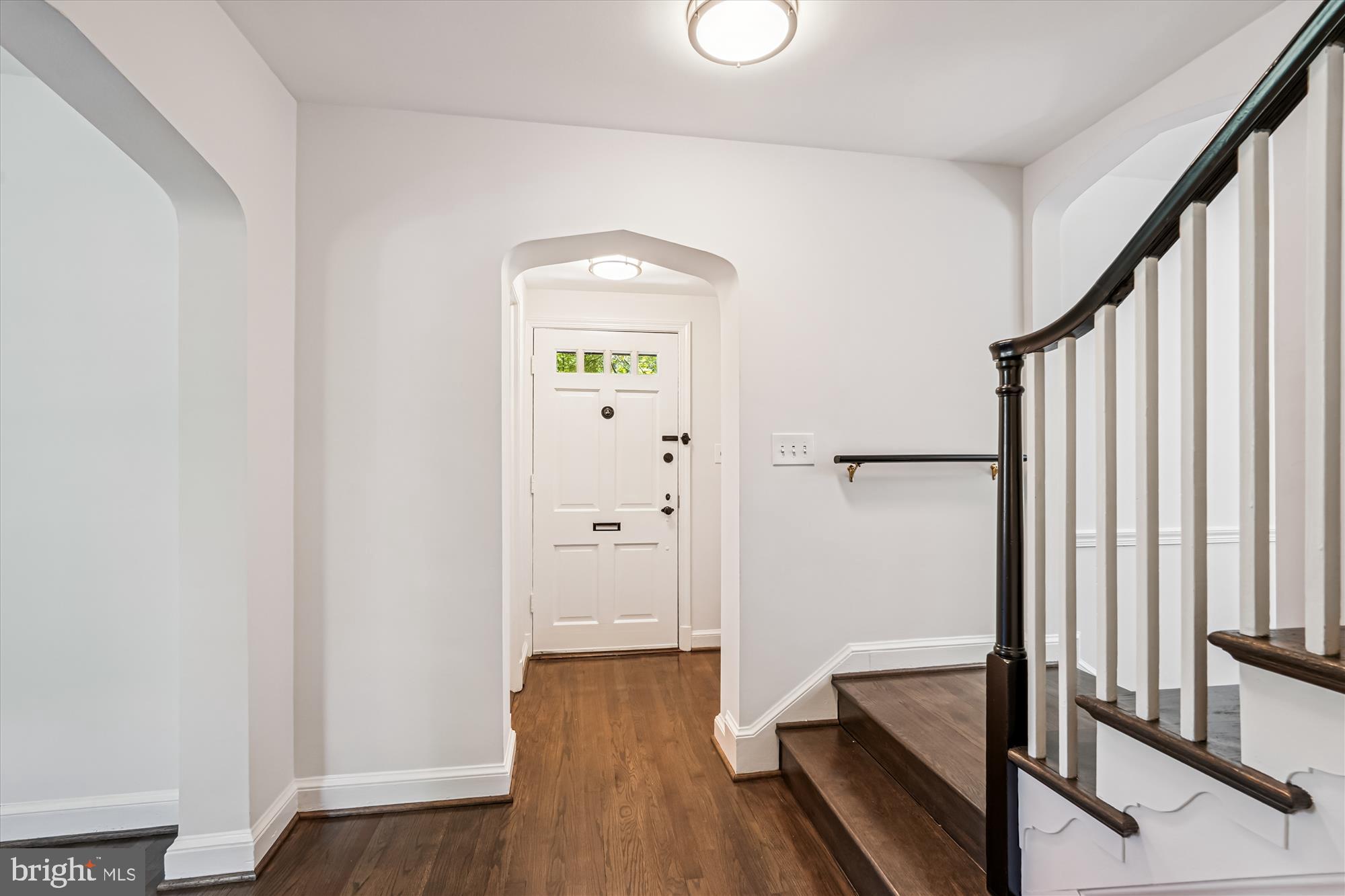 7206 Pinehurst Parkway Chevy Chase, MD 20815 - Photo 2 of 56 a view of a hallway with wooden floor and staircase