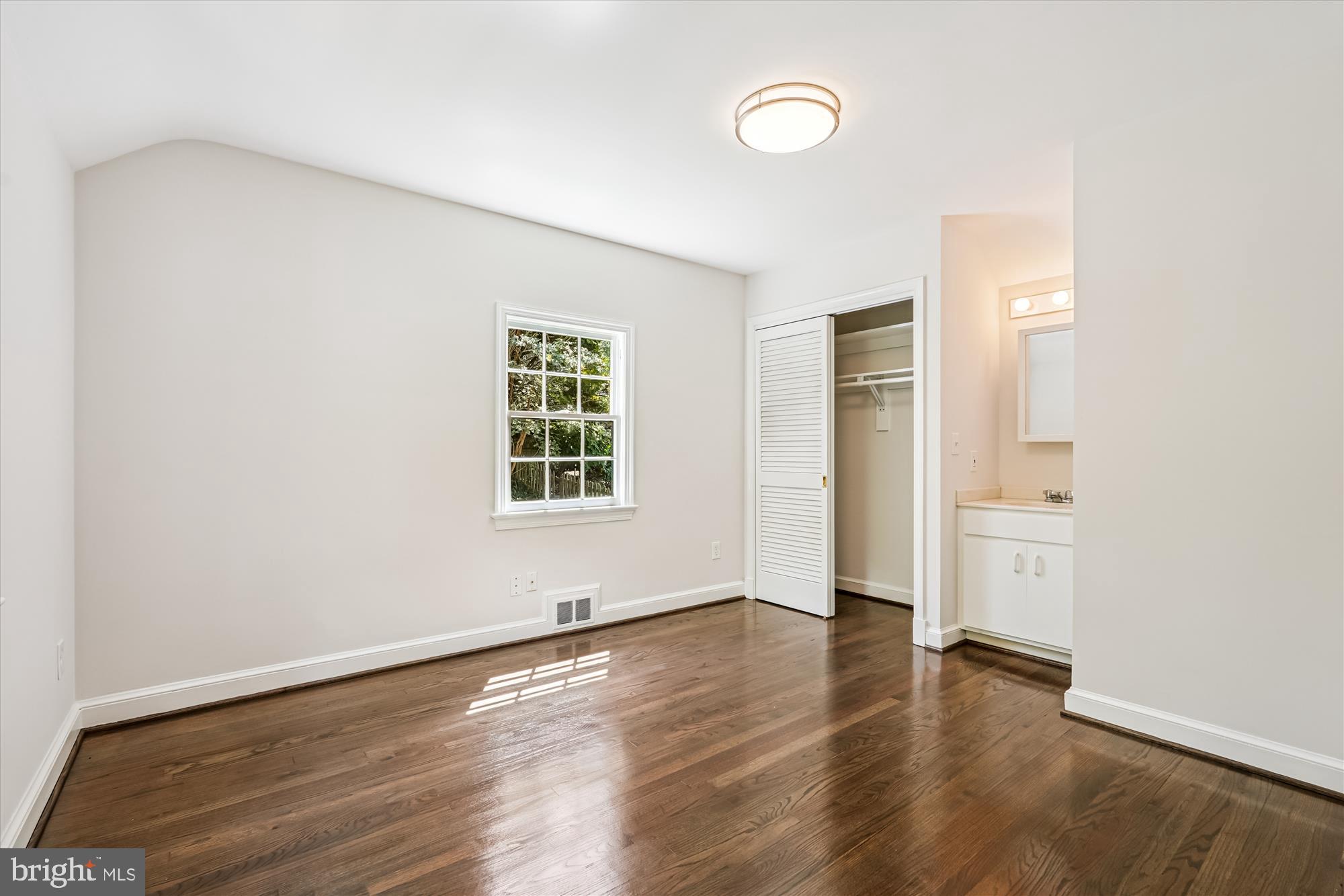 7206 Pinehurst Parkway Chevy Chase, MD 20815 - Photo 27 of 56 an empty room with wooden floor and windows