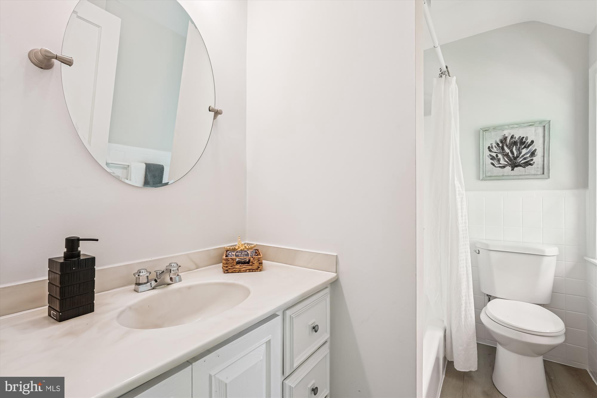7206 Pinehurst Parkway Chevy Chase, MD 20815 - Photo 29 of 56 a bathroom with a sink a toilet and a mirror