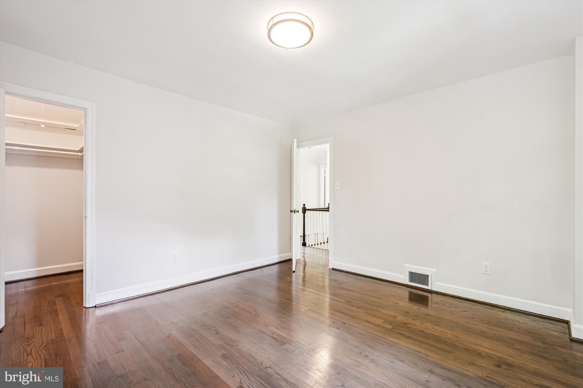 7206 Pinehurst Parkway Chevy Chase, MD 20815 - Photo 31 of 56 an empty room with wooden floor