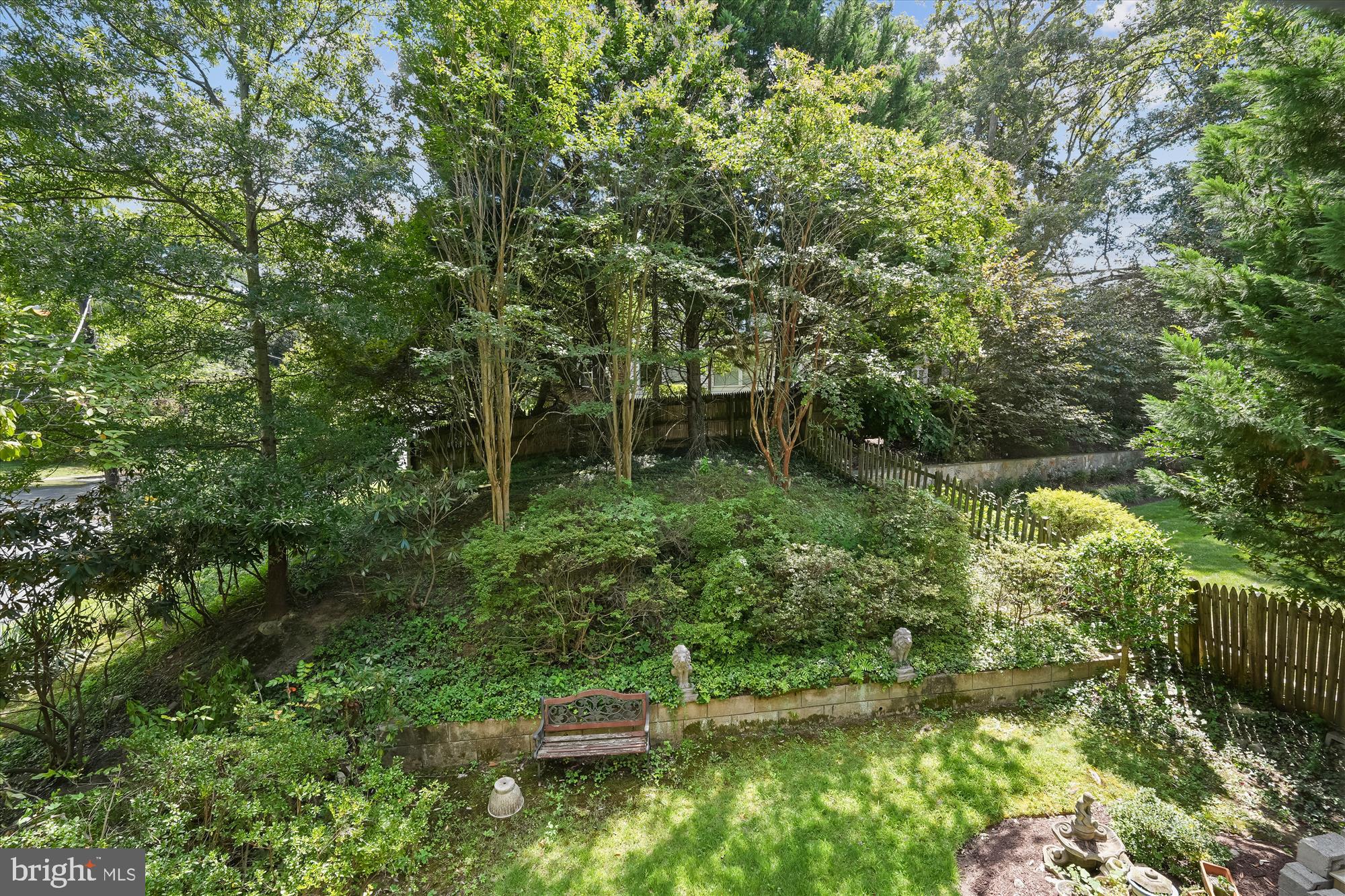 7206 Pinehurst Parkway Chevy Chase, MD 20815 - Photo 46 of 56 a backyard of a house with lots of green space and fountain