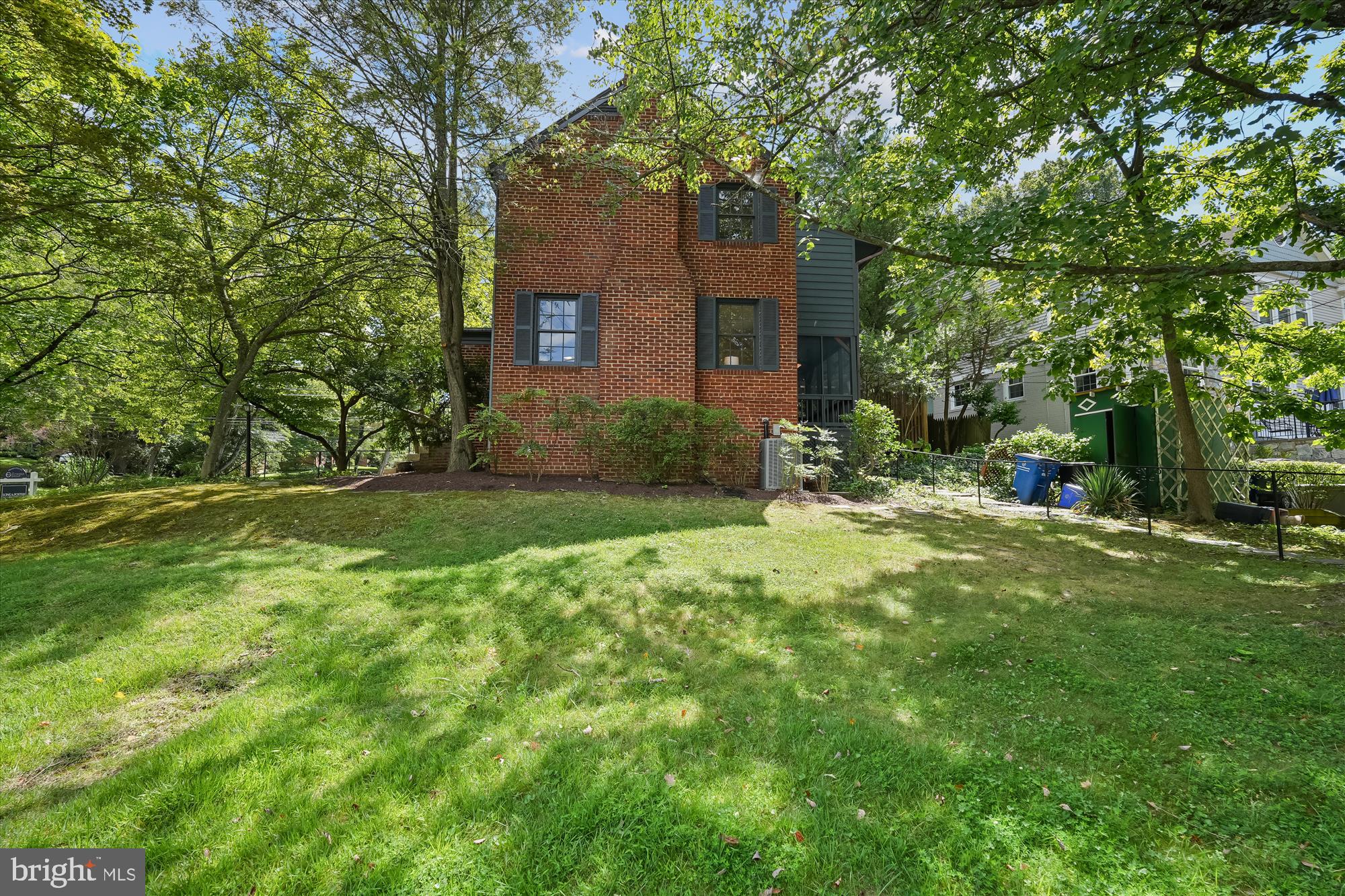 7206 Pinehurst Parkway Chevy Chase, MD 20815 - Photo 47 of 56 a view of a brick house with a yard