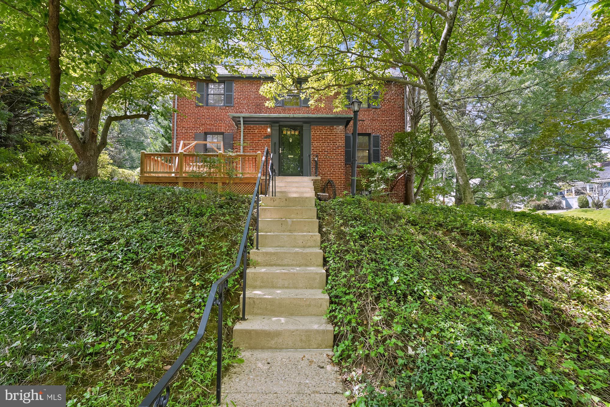 7206 Pinehurst Parkway Chevy Chase, MD 20815 - Photo 49 of 56 a front view of a house with a garden