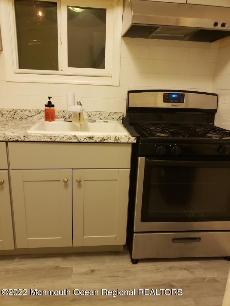 683 Mantoloking Road Brick, NJ 08723 - Photo 2 of 9 a stove top oven sitting inside of a kitchen