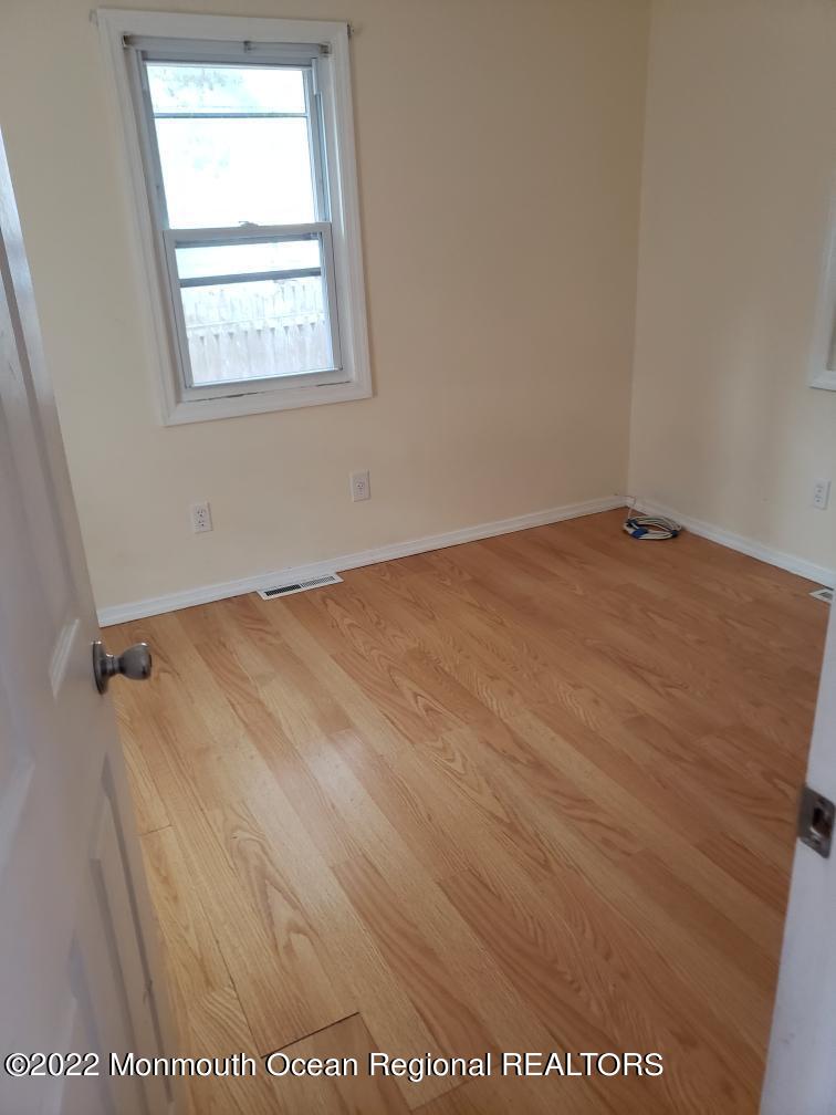 683 Mantoloking Road Brick, NJ 08723 - Photo 5 of 9 an empty room with a window