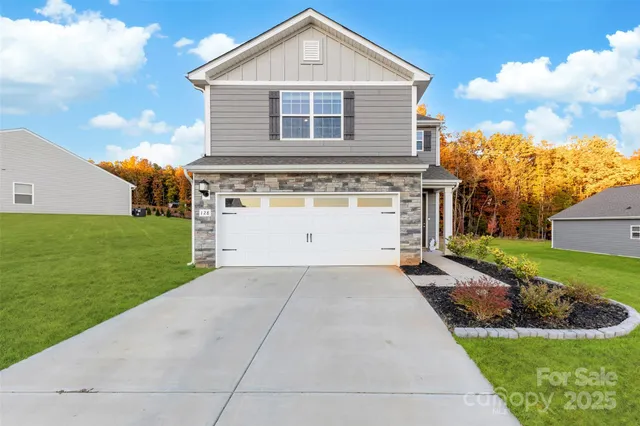 a front view of house with yard and green space