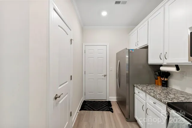 a kitchen with stainless steel appliances a refrigerator and a stove