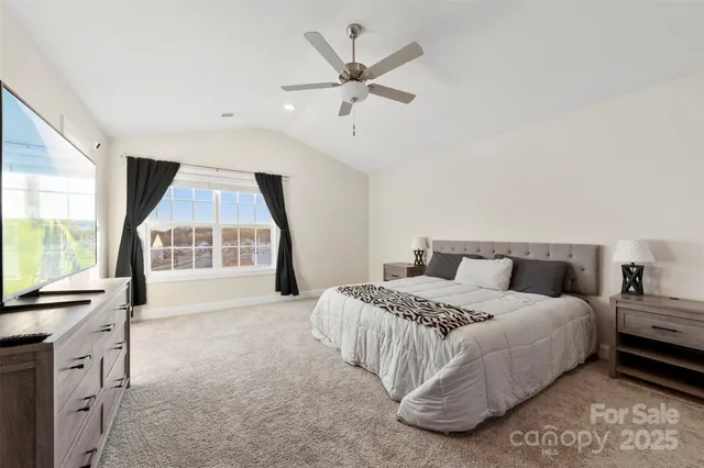 a bedroom with a large bed and a large window