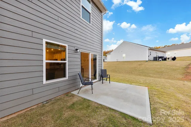a view of a house with backyard and sitting area
