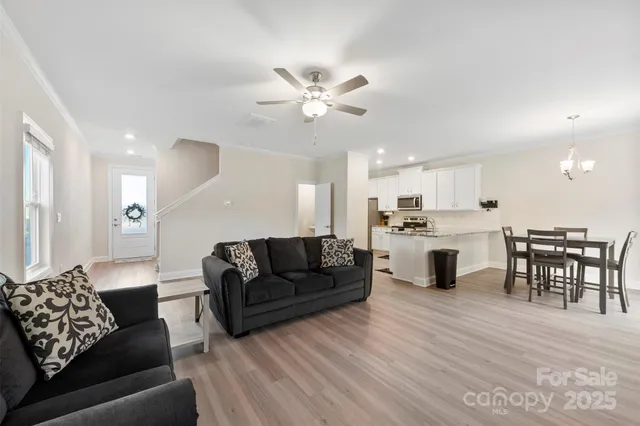 a living room with furniture and kitchen view