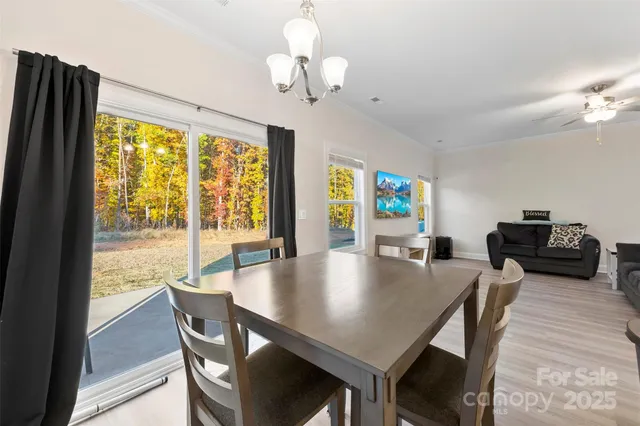 a view of a dining room with furniture and window