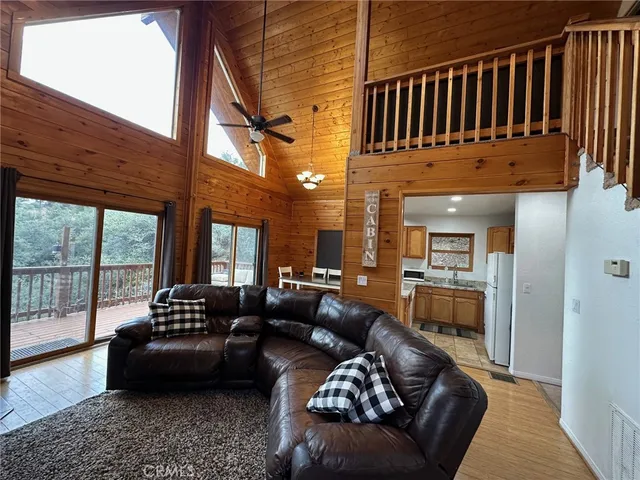 a living room with furniture fireplace and a large window
