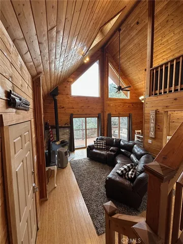 a living room with furniture fireplace and large windows