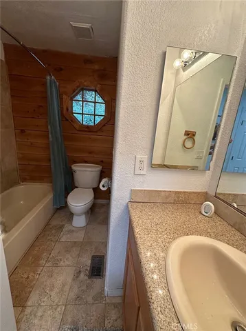 a bathroom with a sink a toilet and bathtub