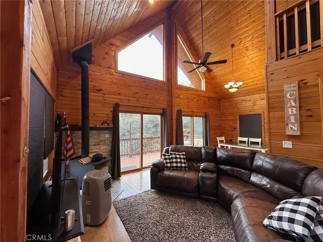 a living room with furniture ceiling fan and a rug