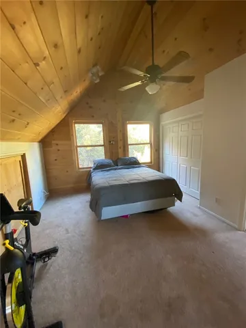 a spacious bedroom with a bed and a large window