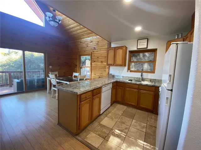 a kitchen with stainless steel appliances granite countertop a stove and a refrigerator