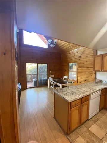 a kitchen with stainless steel appliances granite countertop a sink stove and wooden cabinets