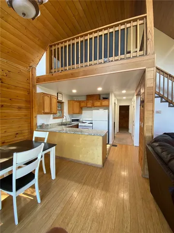 a view of kitchen with wooden floor and electronic appliances