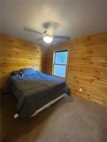 a bedroom with a bed and a view of walk in closet