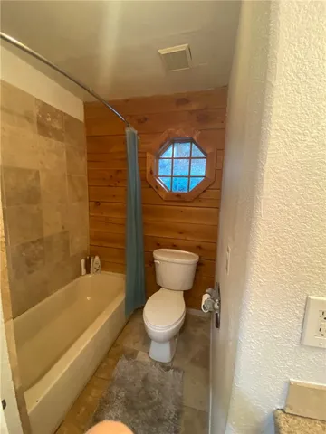 a bathroom with a toilet a sink and bathtub