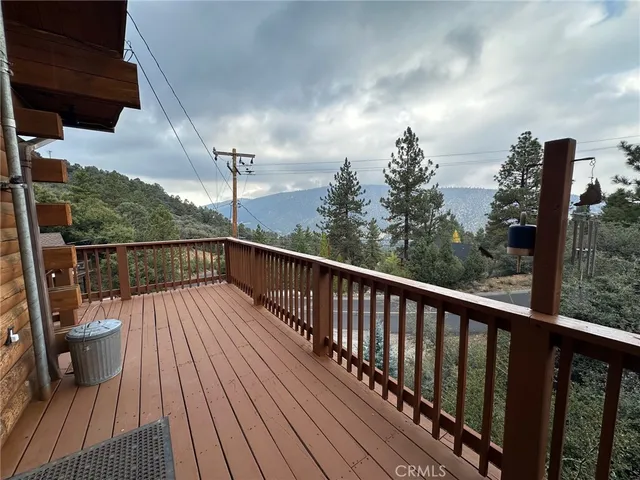 a view of balcony with wooden floor and fence