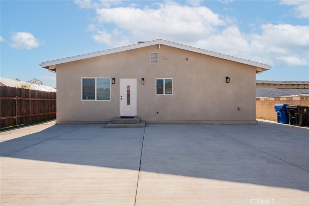 12974 Goleta Street Pacoima, CA 91331 - Photo 2 of 18 a view of house with garage and wooden fence