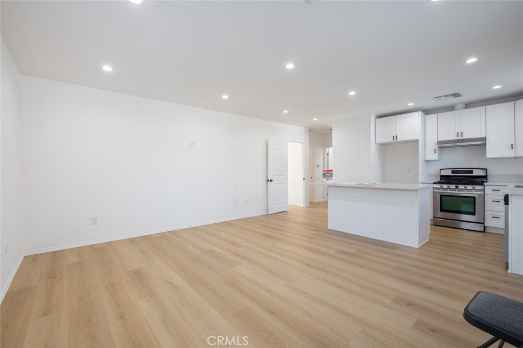 12974 Goleta Street Pacoima, CA 91331 - Photo 7 of 18 a view of kitchen with kitchen island wooden cabinets and stainless steel appliances