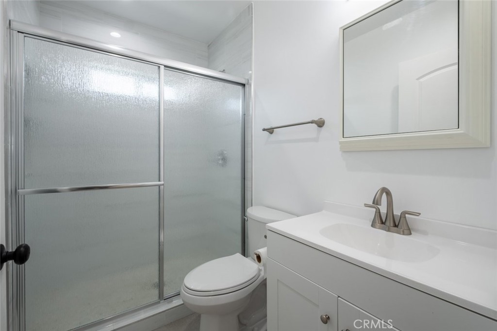 12974 Goleta Street Pacoima, CA 91331 - Photo 10 of 18 a bathroom with a sink a toilet and shower