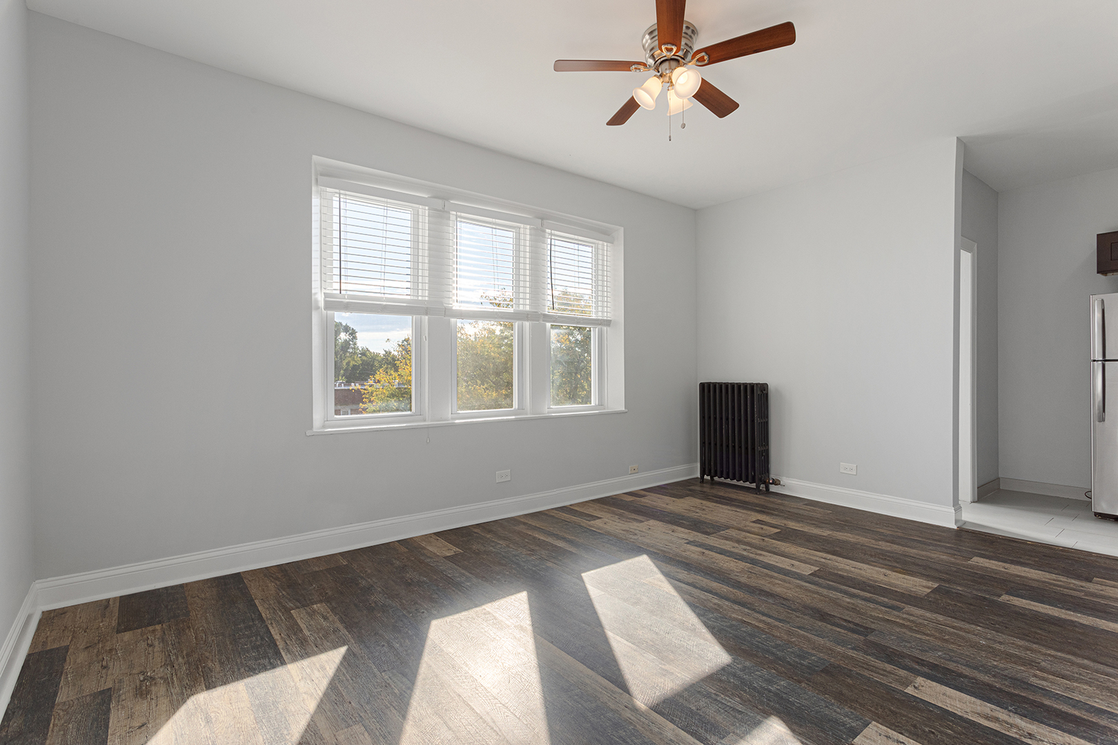 1608 West Sherwin Avenue, Unit 710 Chicago, IL 60626 - Photo 6 of 13 a view of an empty room with wooden floor and a window
