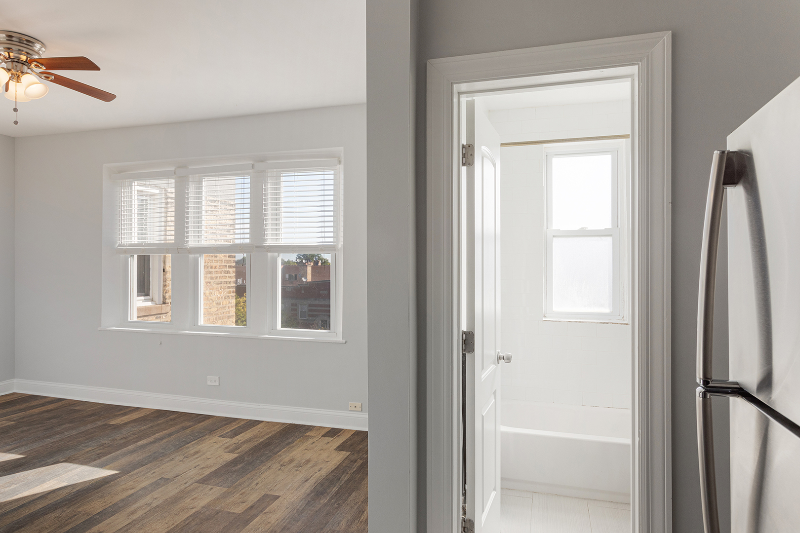 1608 West Sherwin Avenue, Unit 710 Chicago, IL 60626 - Photo 8 of 13 a view of an empty room with wooden floor and a window
