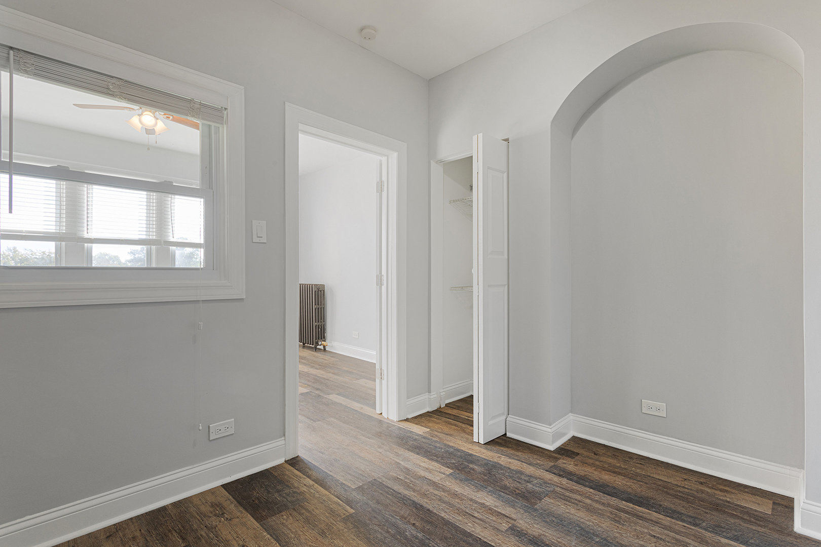 1608 West Sherwin Avenue, Unit 710 Chicago, IL 60626 - Photo 9 of 13 an empty room with wooden floor and windows