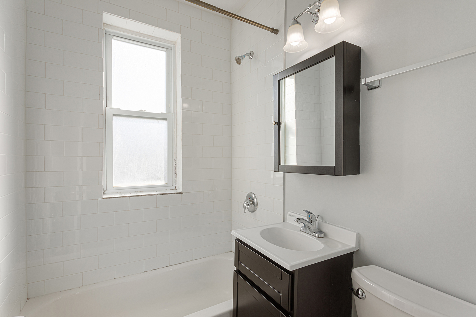 1608 West Sherwin Avenue, Unit 710 Chicago, IL 60626 - Photo 10 of 13 a bathroom with a sink vanity and a mirror