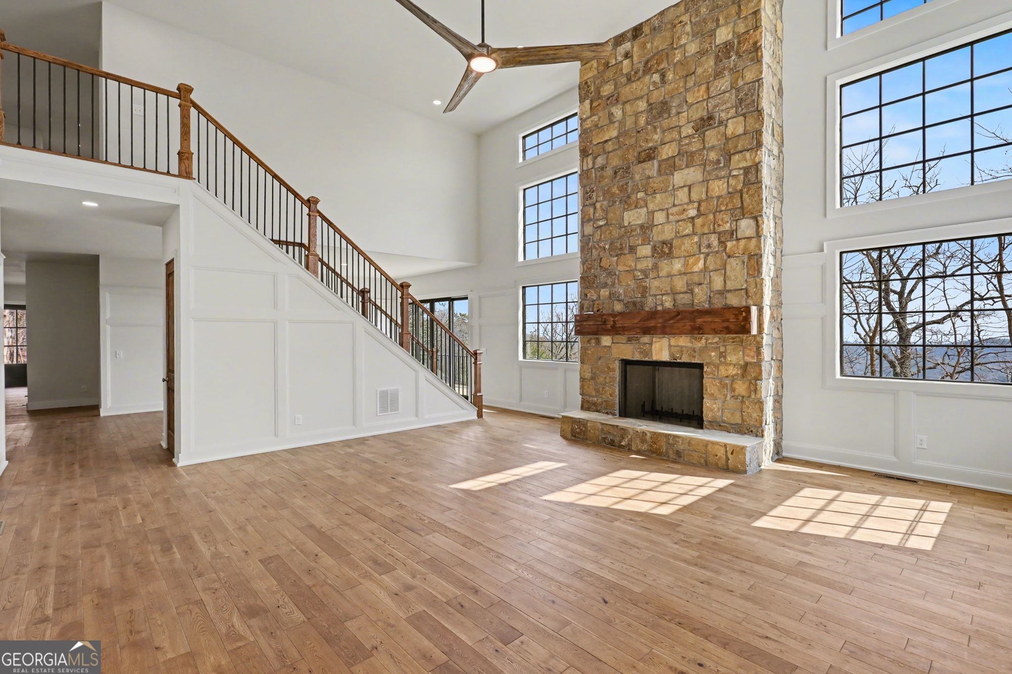 416 Winding View Clayton, GA 30525 - Photo 21 of 61 a view of an empty room with wooden floor a fireplace and windows