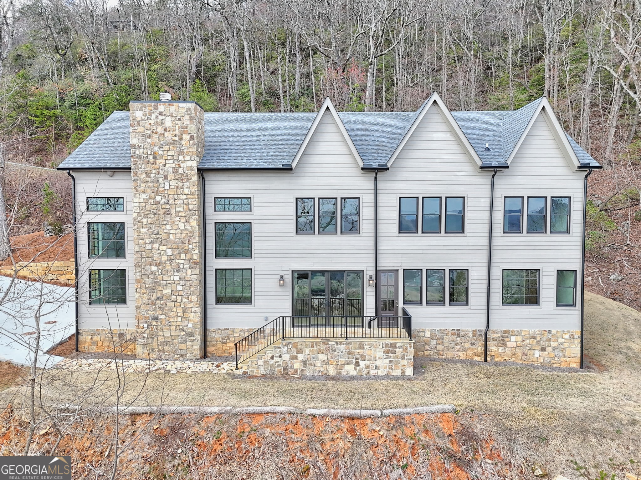 416 Winding View Clayton, GA 30525 - Photo 29 of 61 a view of a white house with large windows and a yard