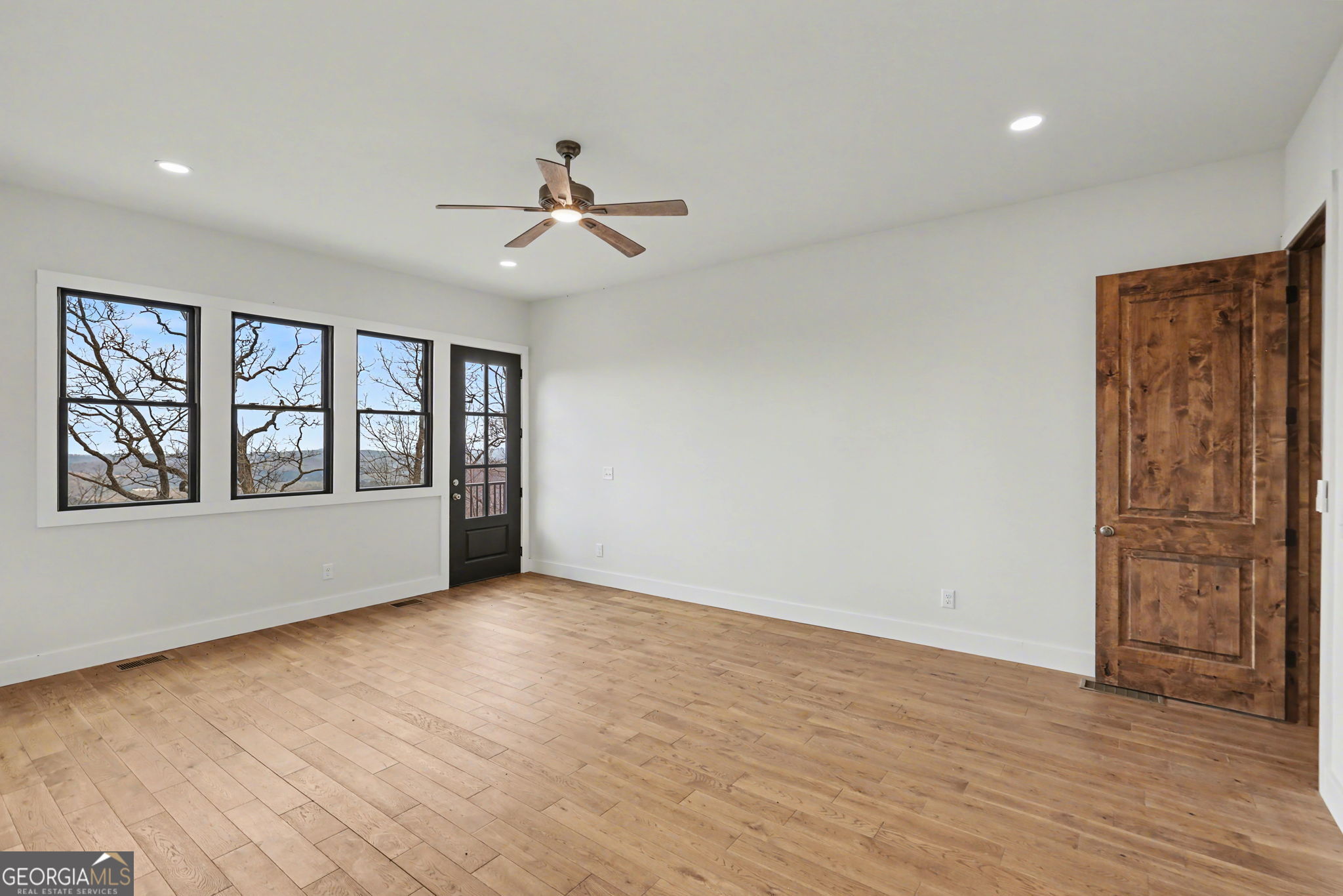 416 Winding View Clayton, GA 30525 - Photo 43 of 61 a view of an empty room with a window and wooden floor