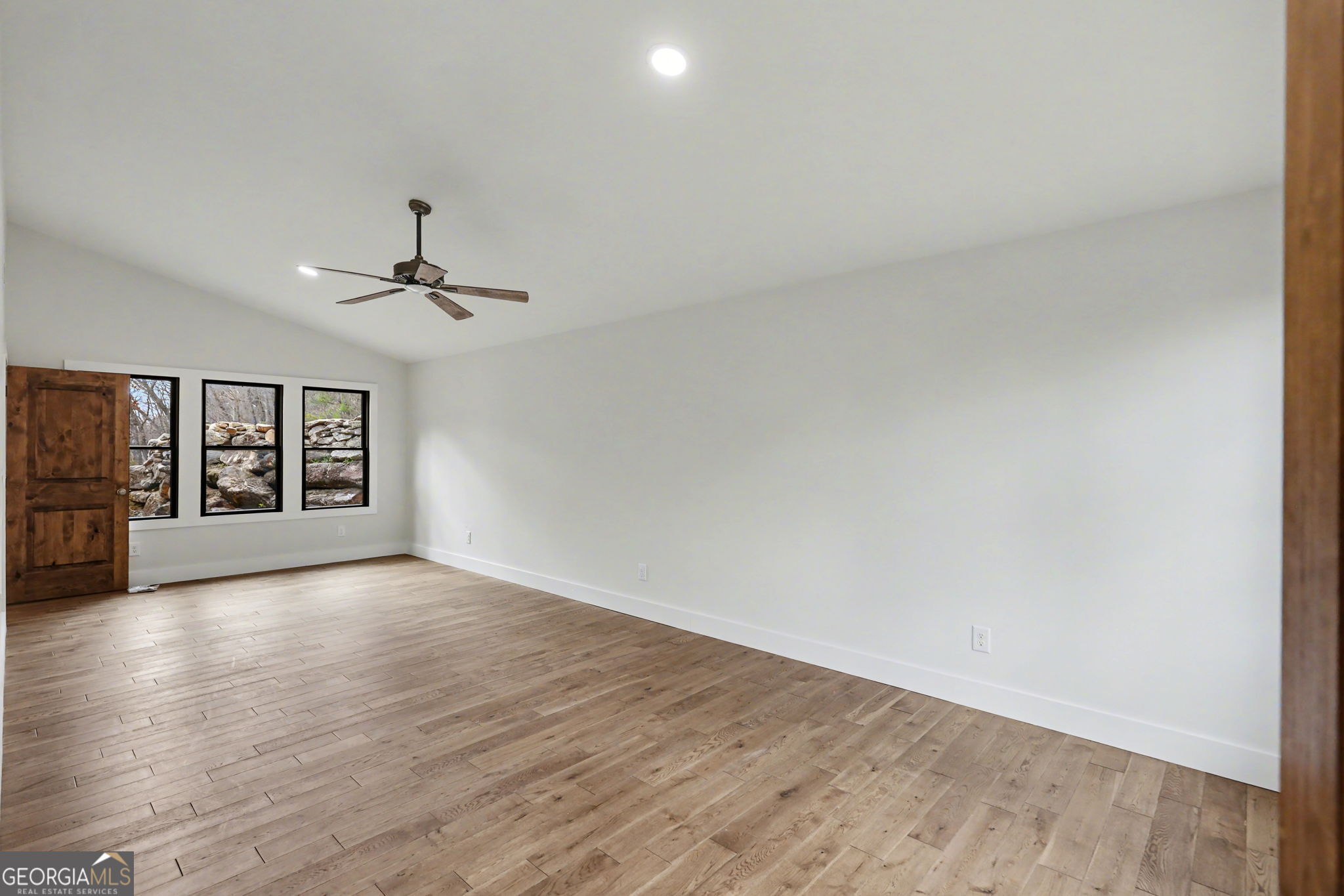 416 Winding View Clayton, GA 30525 - Photo 49 of 61 a view of an empty room with a window and wooden floor