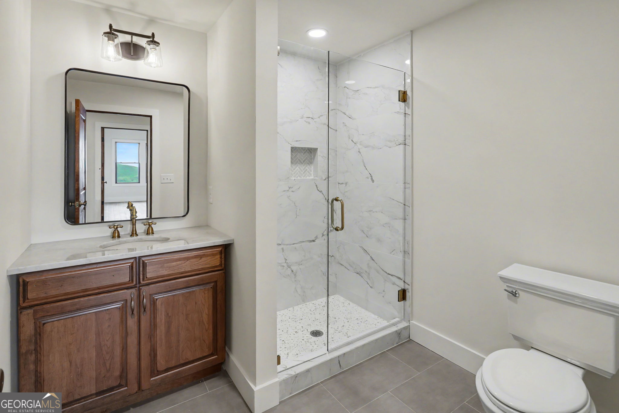 416 Winding View Clayton, GA 30525 - Photo 51 of 61 a bathroom with a toilet a sink a glass door a shower and vanity
