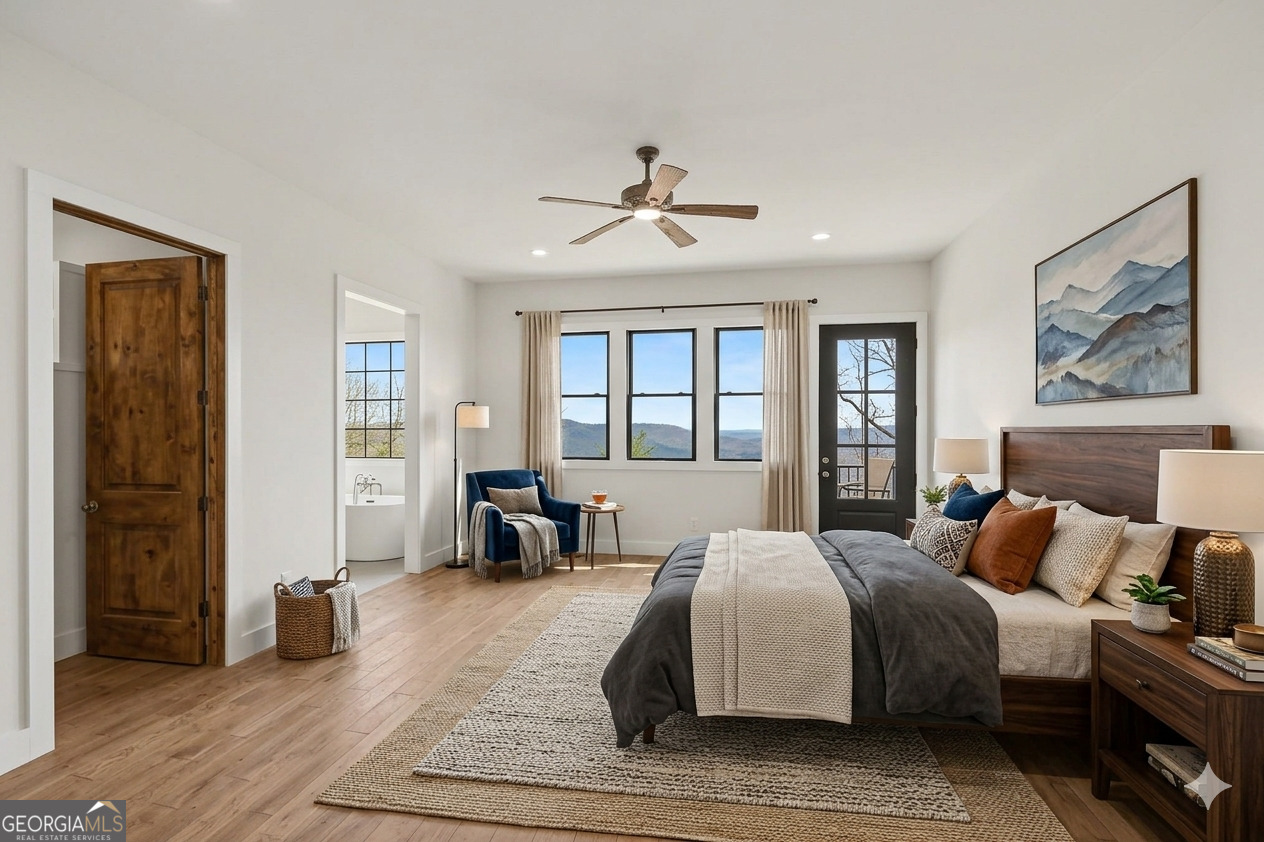 416 Winding View Clayton, GA 30525 - Photo 10 of 61 a spacious bedroom with a large bed a chandelier and windows