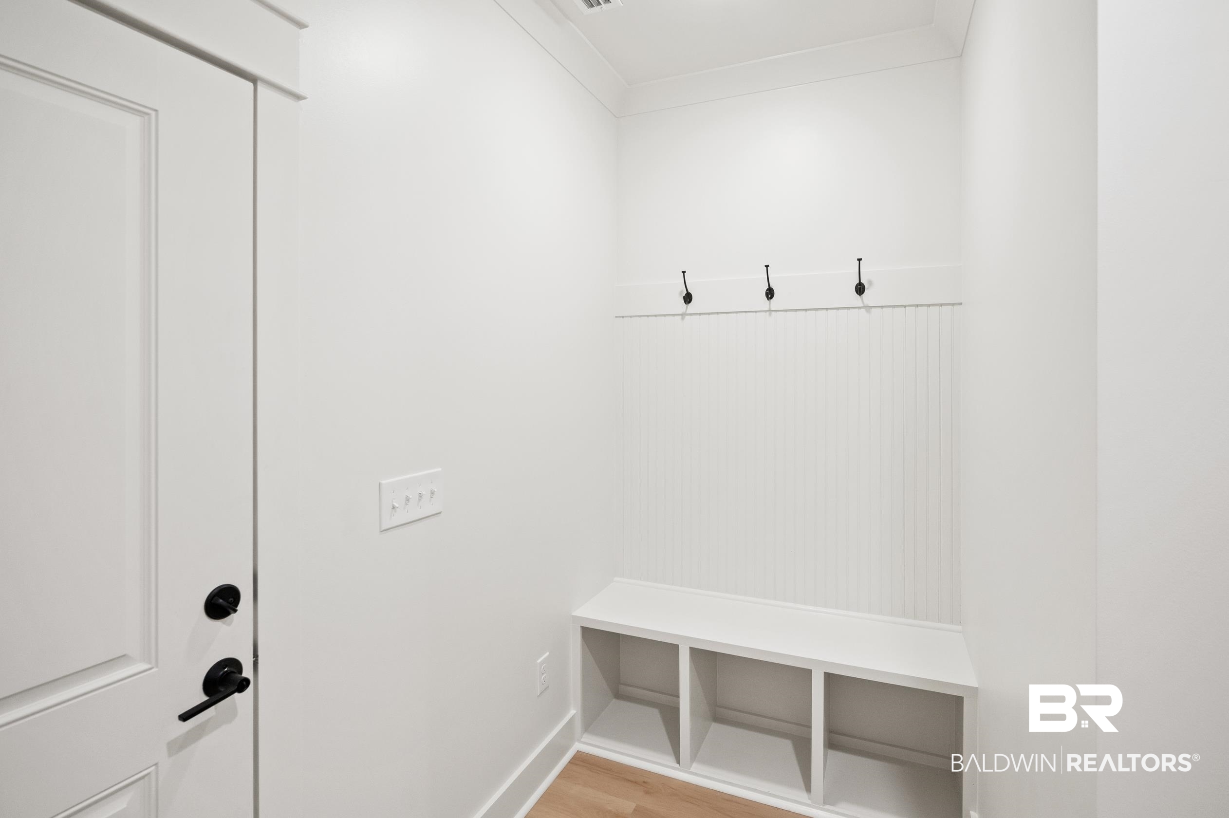 28889 Canal Road Orange Beach, AL 36561 - Photo 19 of 55 Mudroom featuring light hardwood / wood-style flooring and ornamental molding