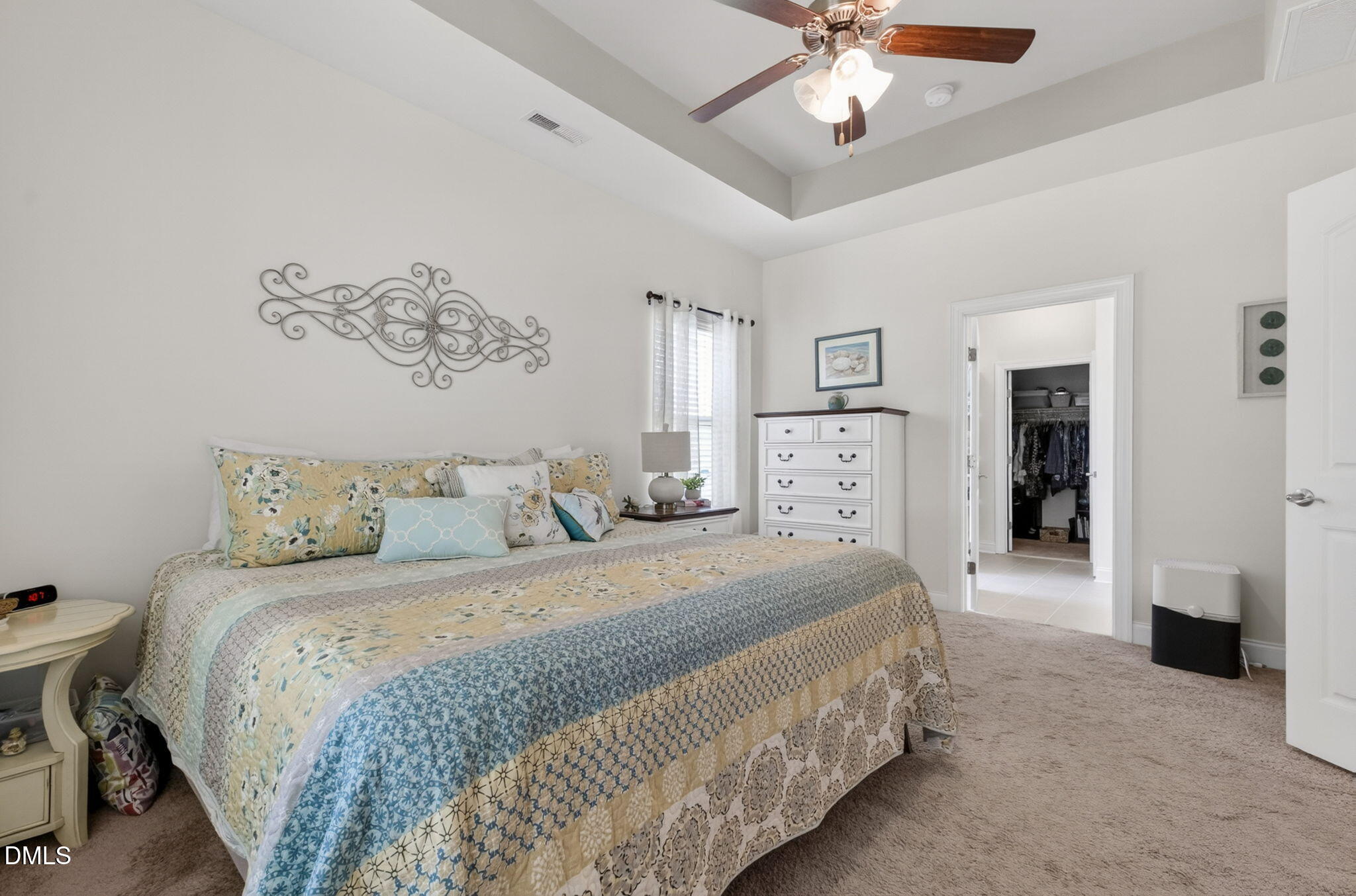 20 Deep Clay Circle Angier, NC 27501 - Photo 27 of 54 a spacious bedroom with a large bed and a chandelier