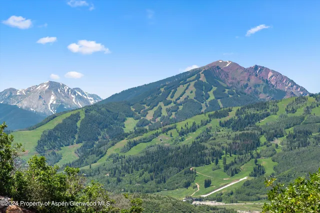 a view of a big building with a mountain in the background