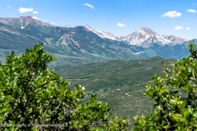 a view of a house with a mountain in the background