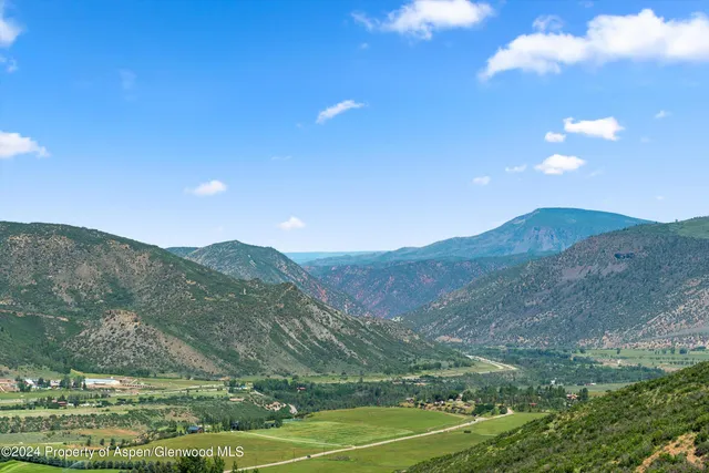 a view of a town with mountains in the background