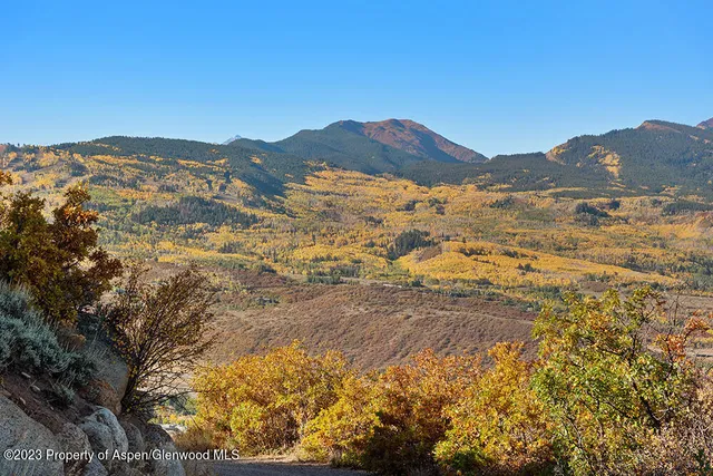 a view of a mountain range in a cloudy sky