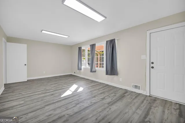 a living room with hard wood floors and a wooden floor