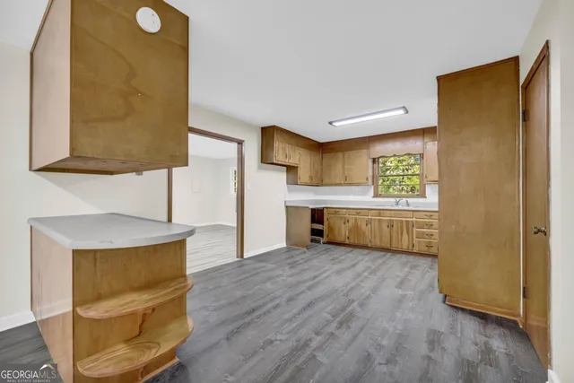 a view of empty room with wooden floor and window