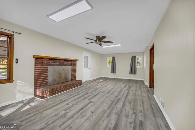 an empty room with wooden floor and closet