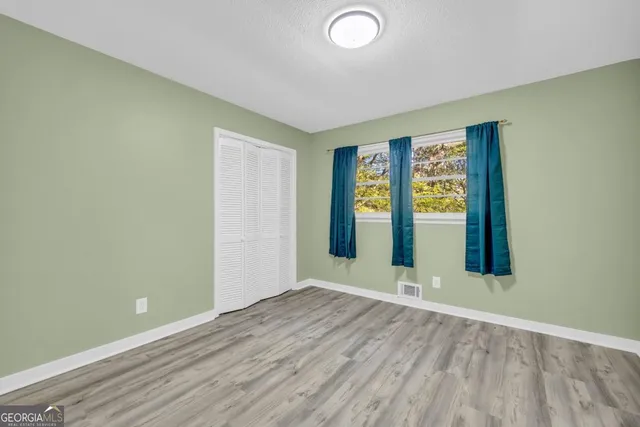 a bathroom with a sink a toilet and a window