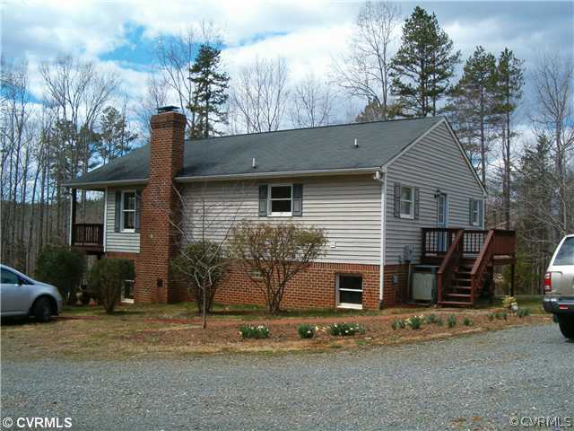 3938 Whitehall Road Sandy Hook, VA 23153 - Photo 23 of 23 a front view of a house with garden
